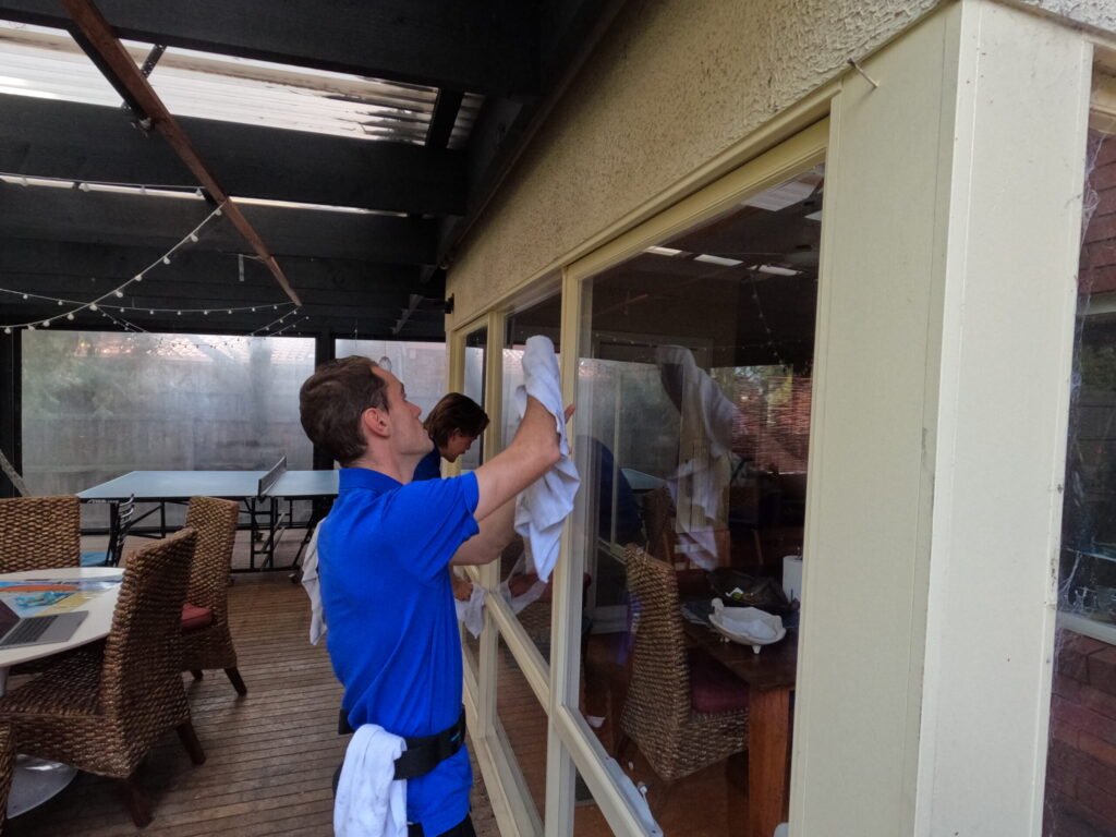 Residential window cleaners cleaning ground floor window at a home in the eastern suburbs.