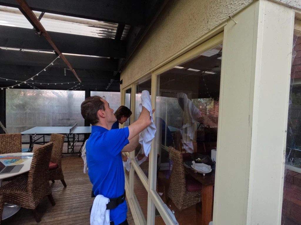 Residential window cleaners cleaning ground floor window at a home in the eastern suburbs.
