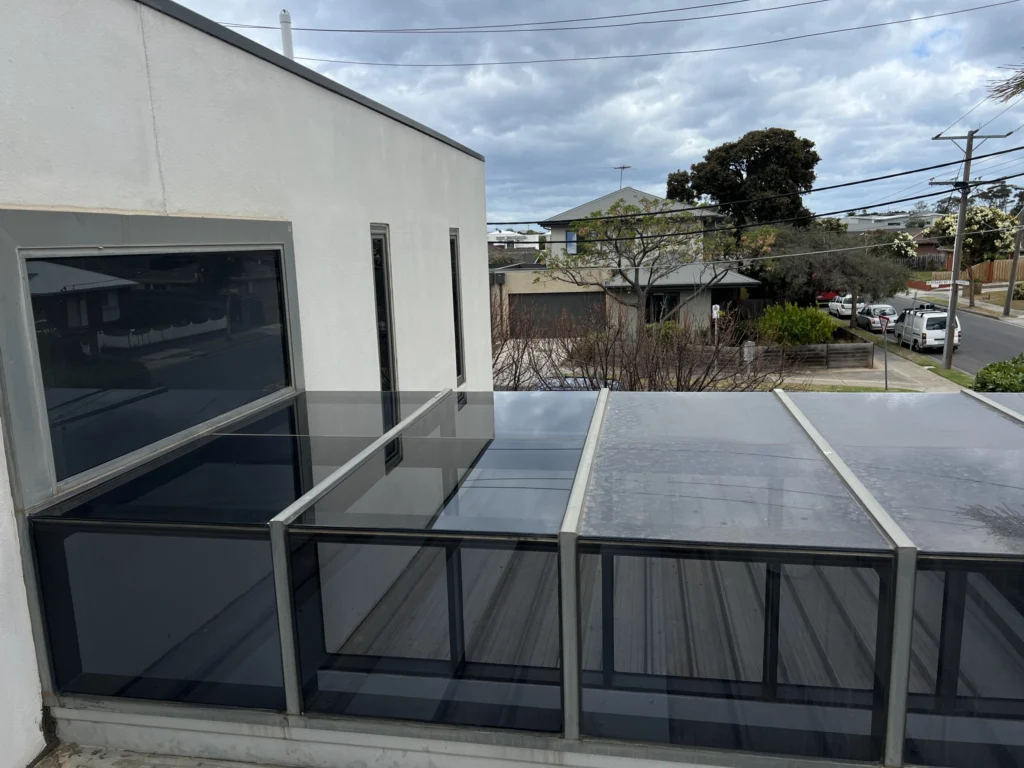 A side by side view of a residential skylight being cleaing from the outside.